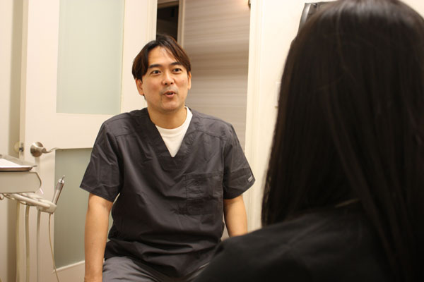 Rihito Matsui DDS discussing dental treatment options with a patient